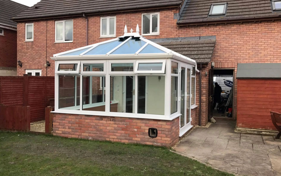White uPVC edwardian conservatory with a glass roof